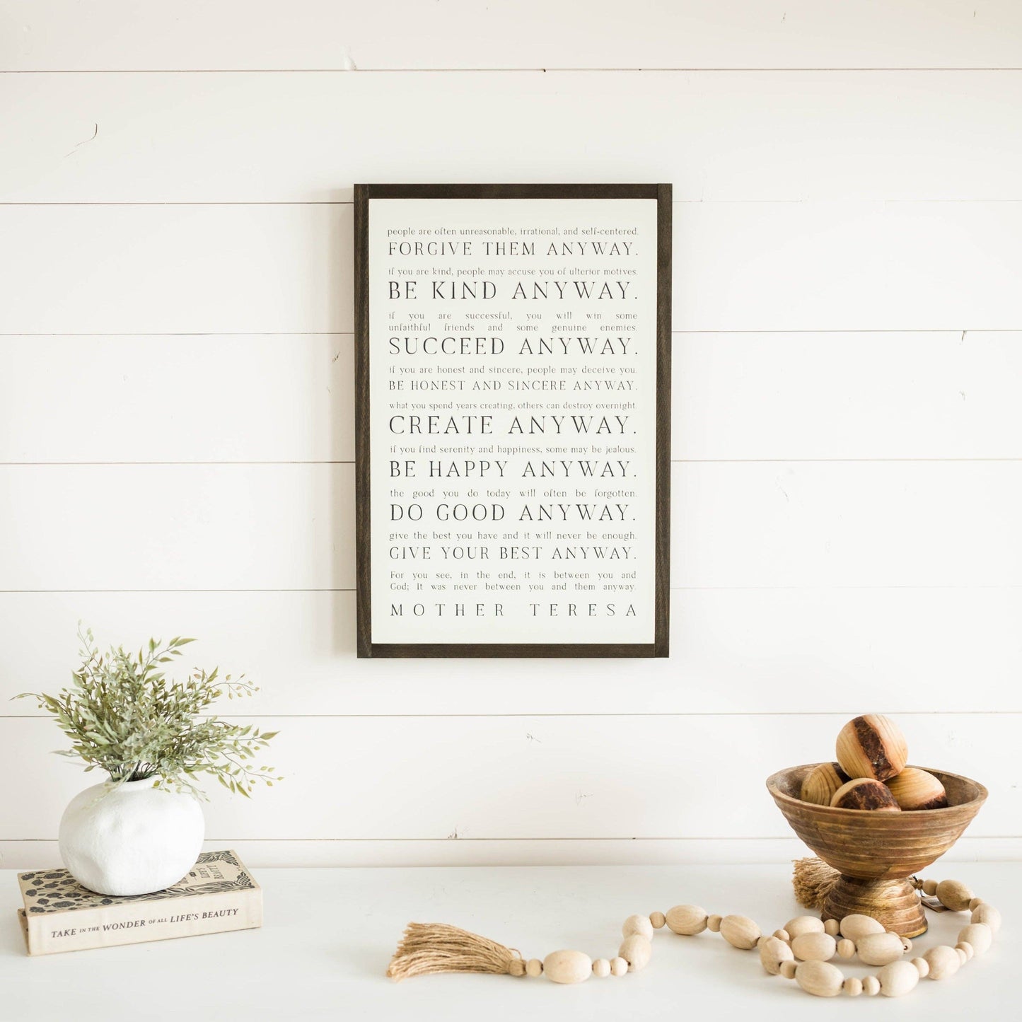 Love them Anyway | Mother Teresa | Wall Art: Soft White-Black Text / Light Brown Frame / 16 inches x 24 inches