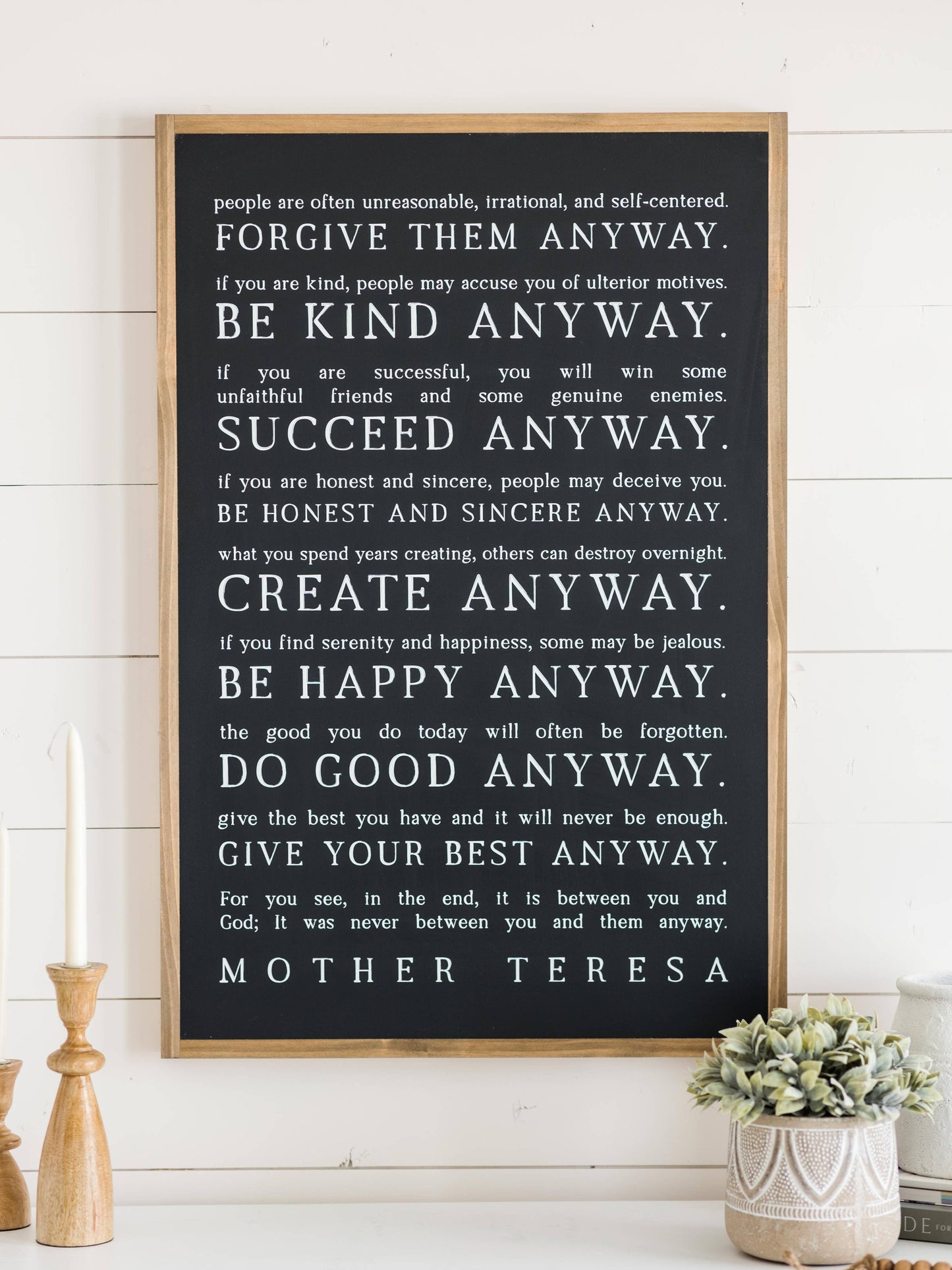 Love them Anyway | Mother Teresa | Wall Art: Soft White-Black Text / Light Brown Frame / 16 inches x 24 inches