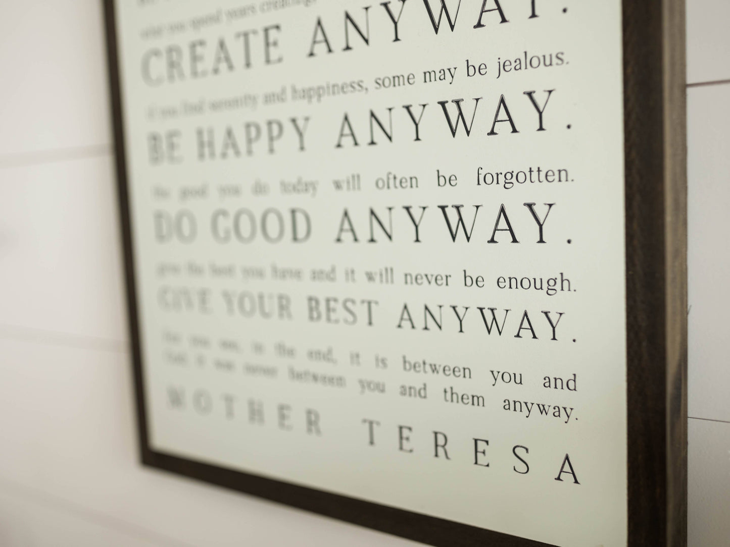 Love them Anyway | Mother Teresa | Wall Art: Soft White-Black Text / Light Brown Frame / 16 inches x 24 inches