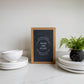 Wash the Plate | Wall Art: Black-White Text / Dark Brown Frame / 8 inches x 12 inches